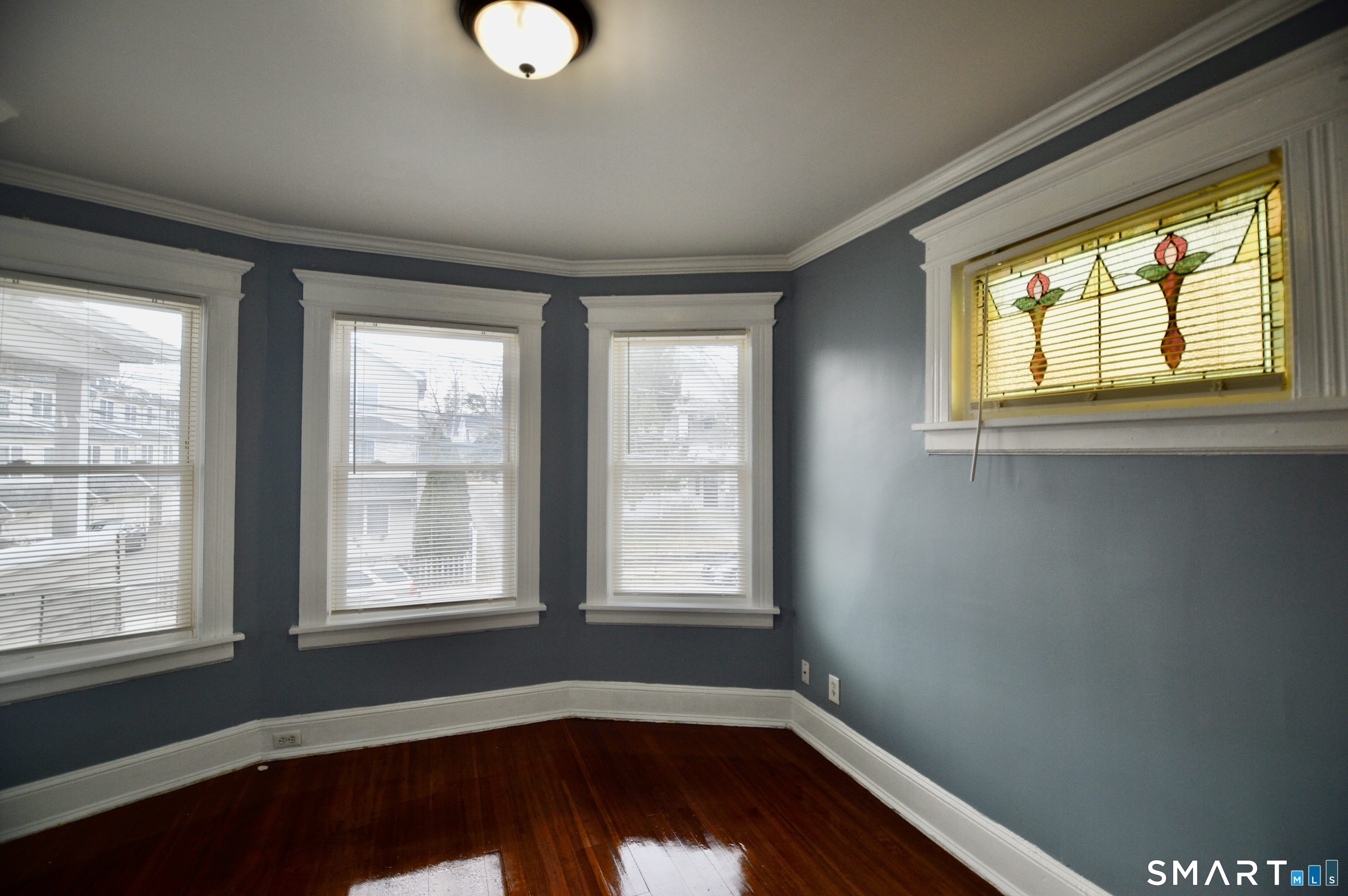 32 Boston Terrace Bridgeport, CT 06610 - Photo 3 of 14 a view of an empty room with wooden floor and a window