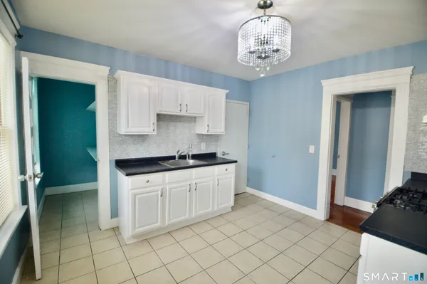 a kitchen with a cabinets and chandelier