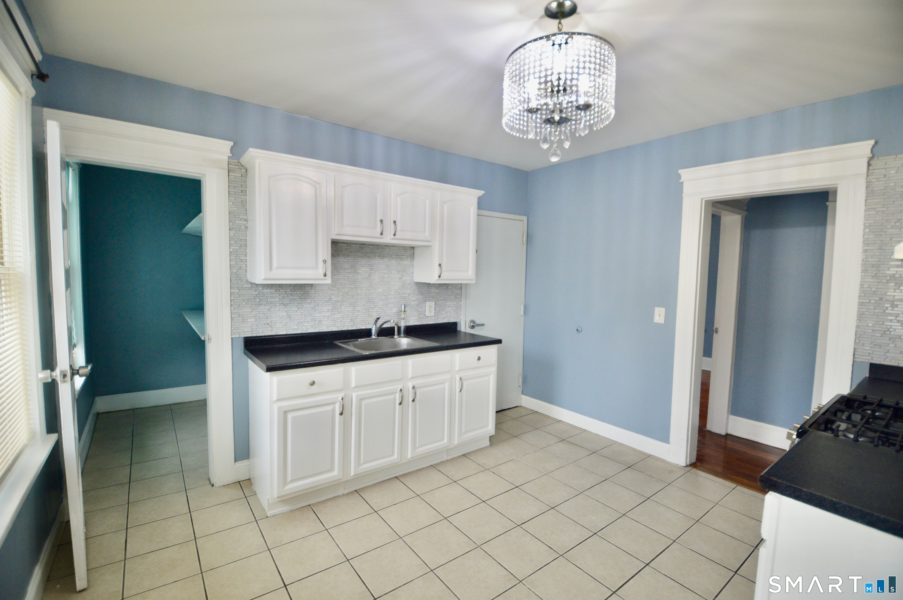32 Boston Terrace Bridgeport, CT 06610 - Photo 7 of 14 a kitchen with a cabinets and chandelier
