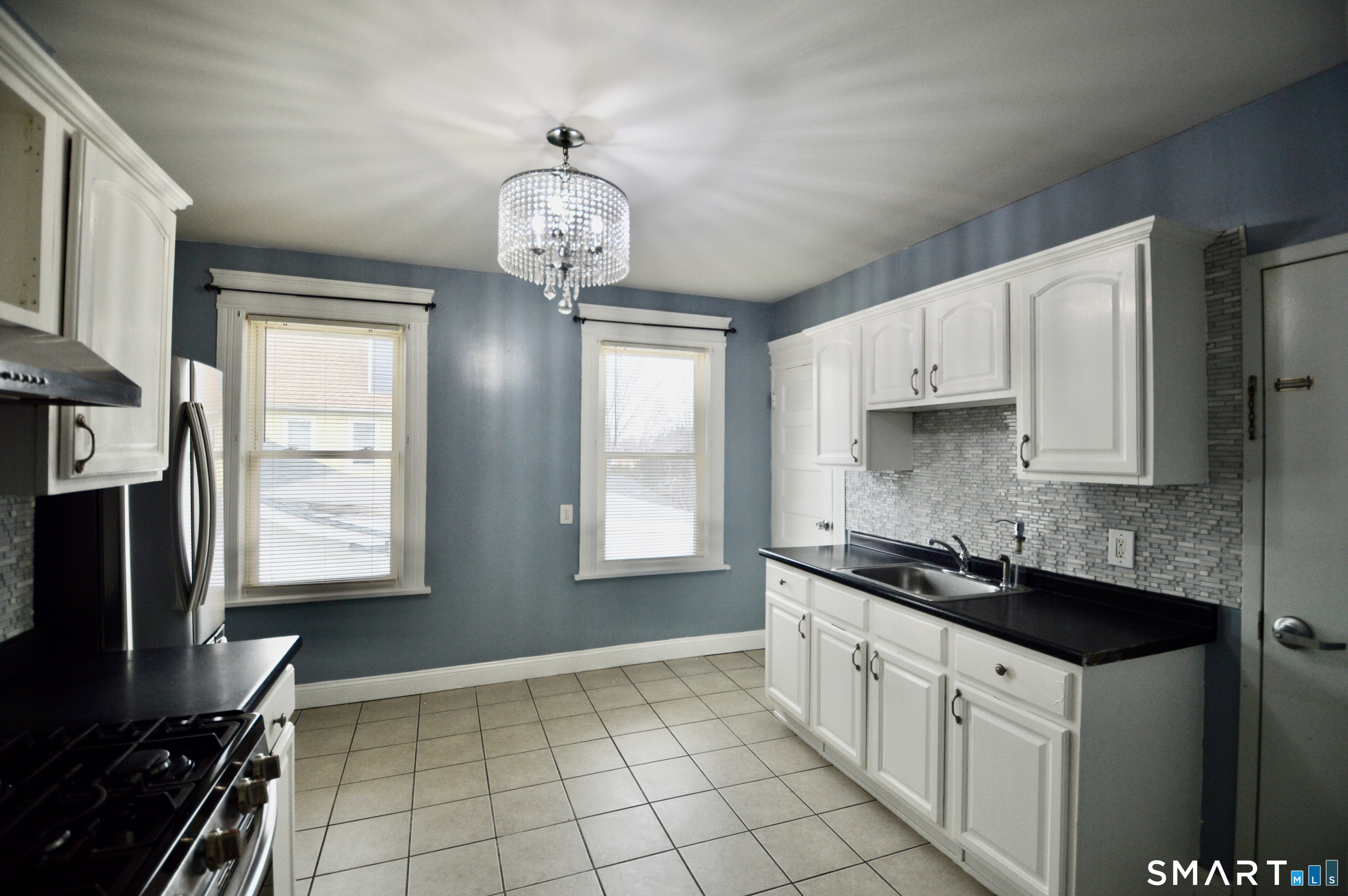 32 Boston Terrace Bridgeport, CT 06610 - Photo 9 of 14 a kitchen with stainless steel appliances granite countertop a sink stove and cabinets