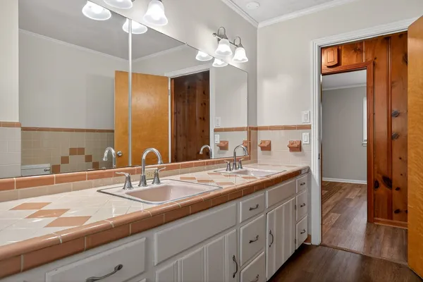 a bathroom with a sink double vanity and a mirror