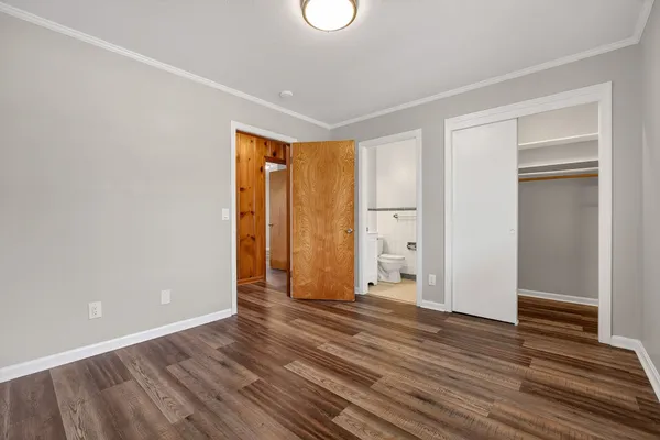 a view of an empty room with wooden floor