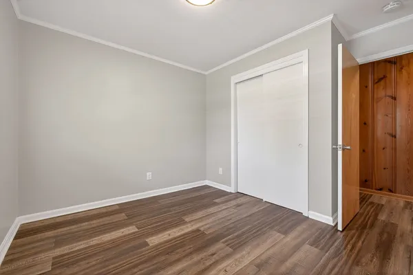 a view of room with wooden floor