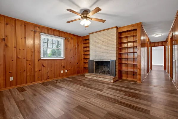 wooden floor in an empty room with a fireplace