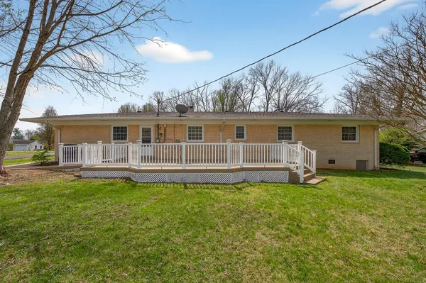 a house view with a sitting space and garden