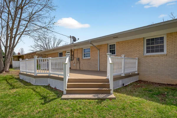 a view of house with backyard