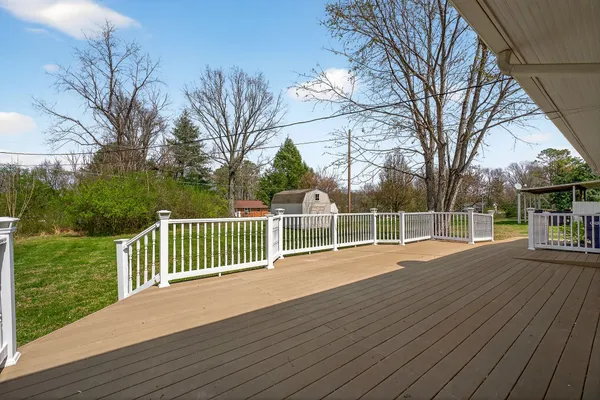 a view of a deck with wooden floor and fence