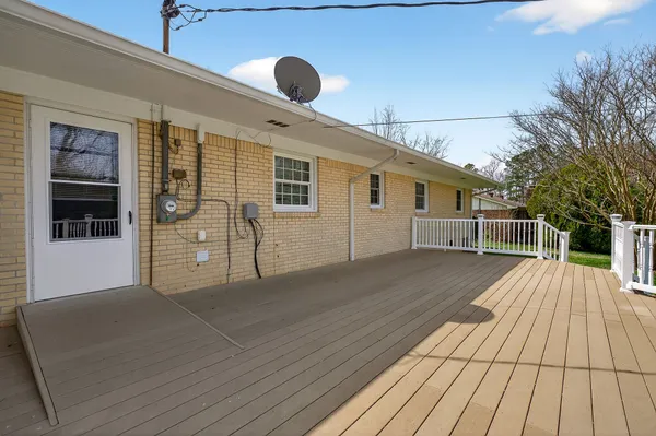 a view of a house with a wooden deck
