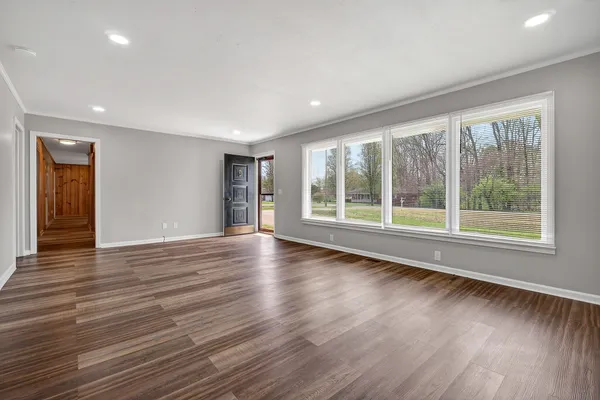 a view of room with window and wooden floor
