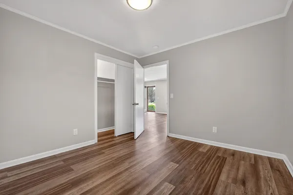 a view of an empty room with wooden floor