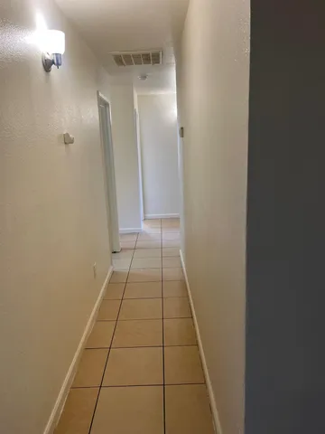 a view of hallway with a white door