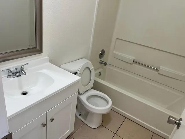 a white toilet sitting next to a bathroom sink
