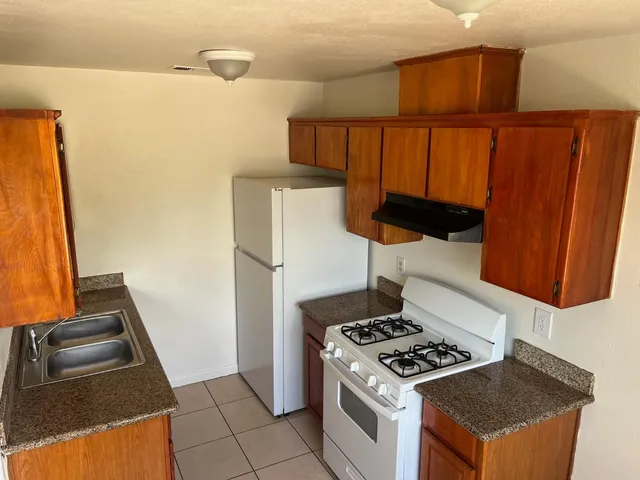 a stove top oven sitting inside of a kitchen