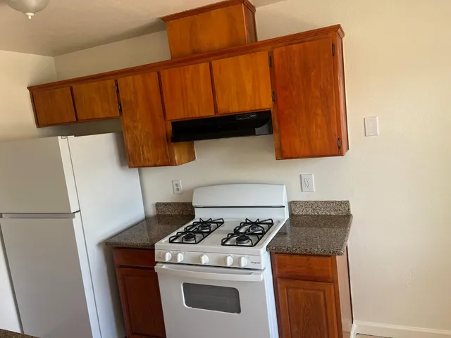 a kitchen with a stove and a refrigerator