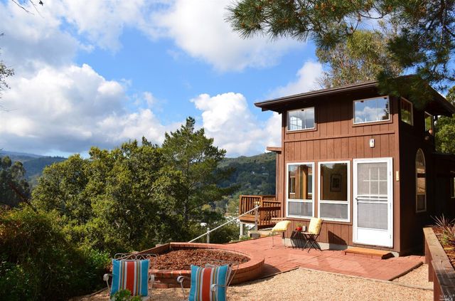 a backyard of a house with table and chairs