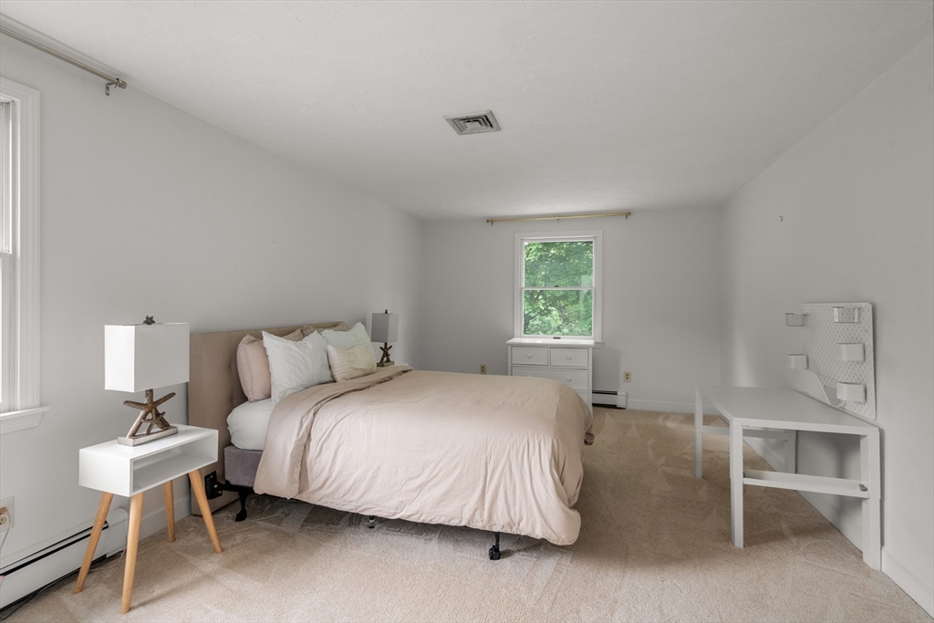 322 Concord Road Wayland, MA 01778 - Photo 20 of 35 a bedroom with a bed and a table