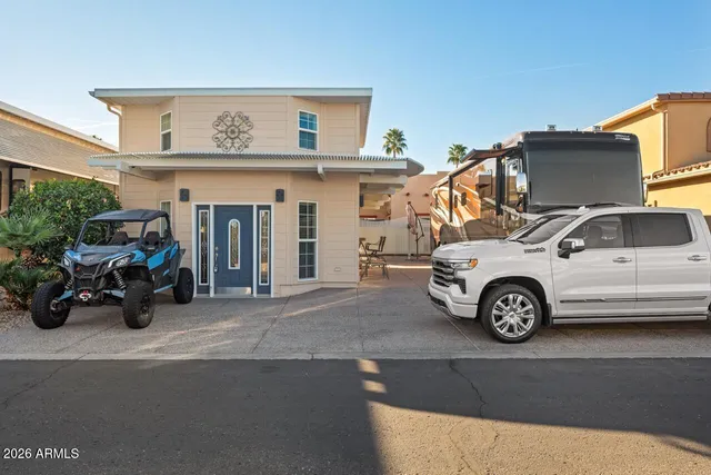 a living room with furniture a rug and white walls