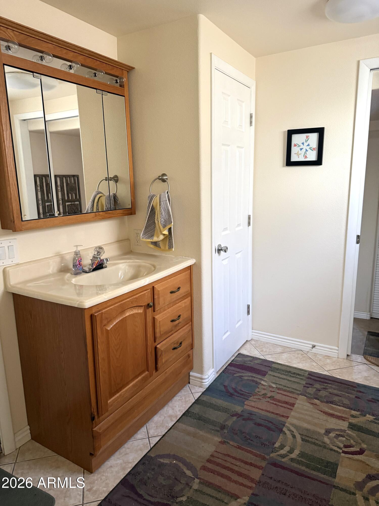 17200 West Bell Road, Unit 1784 Surprise, AZ 85374 - Photo 13 of 25 a bathroom with a sink and a mirror