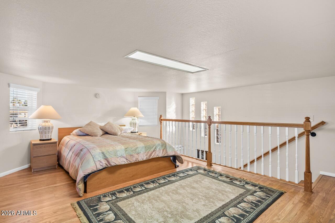 17200 West Bell Road, Unit 1784 Surprise, AZ 85374 - Photo 16 of 25 a bedroom with a bed and window