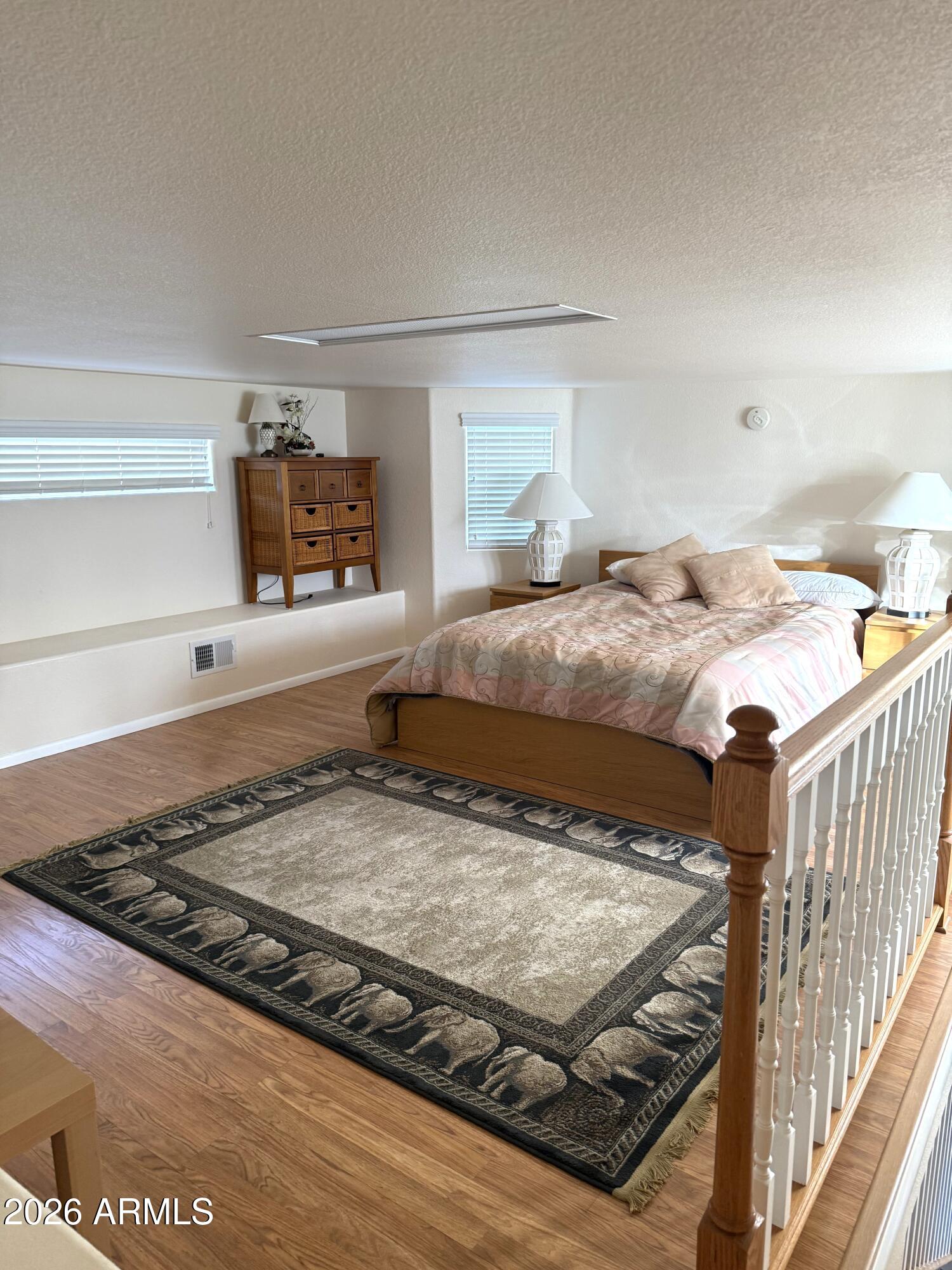 17200 West Bell Road, Unit 1784 Surprise, AZ 85374 - Photo 17 of 25 a bedroom with a bed and a flat screen tv