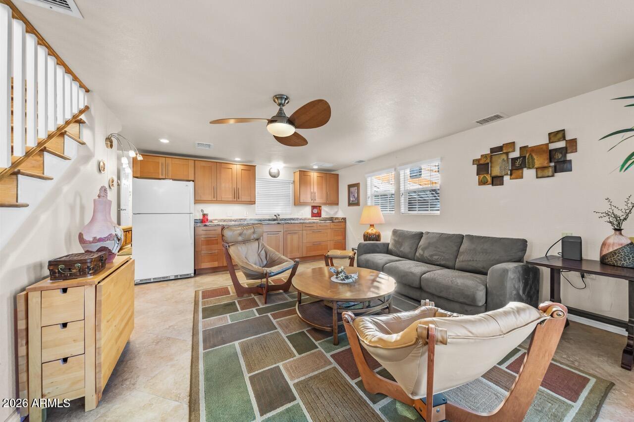 17200 West Bell Road, Unit 1784 Surprise, AZ 85374 - Photo 2 of 25 a living room with furniture a rug and white walls