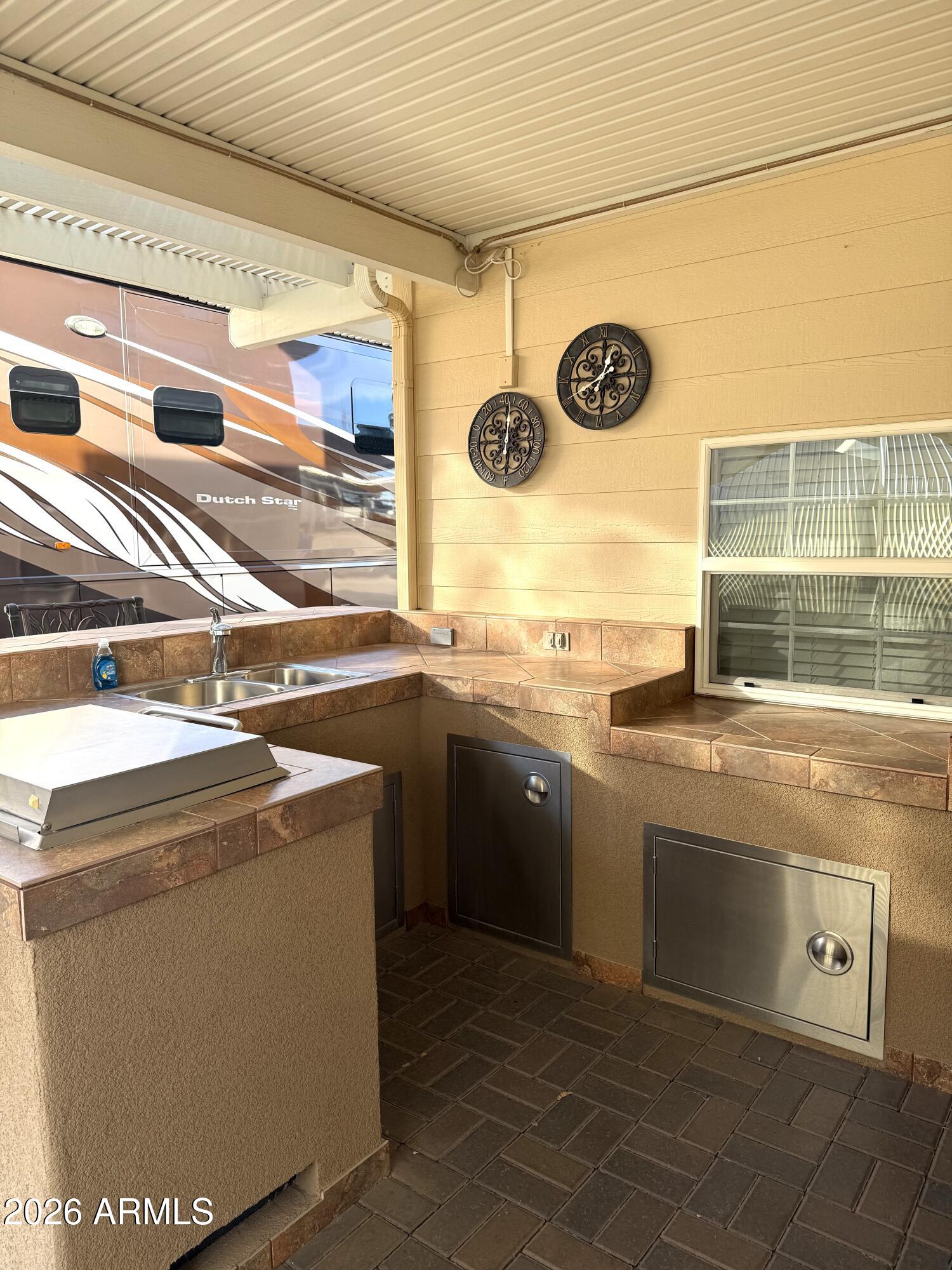 17200 West Bell Road, Unit 1784 Surprise, AZ 85374 - Photo 22 of 25 a kitchen with stainless steel appliances granite countertop a sink and a stove
