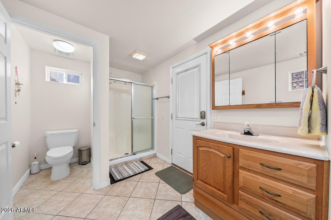 17200 West Bell Road, Unit 1784 Surprise, AZ 85374 - Photo 3 of 25 a bathroom with a sink a toilet and a large mirror