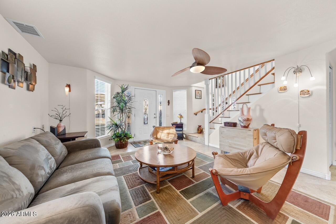 17200 West Bell Road, Unit 1784 Surprise, AZ 85374 - Photo 8 of 25 a living room with furniture a rug and white walls