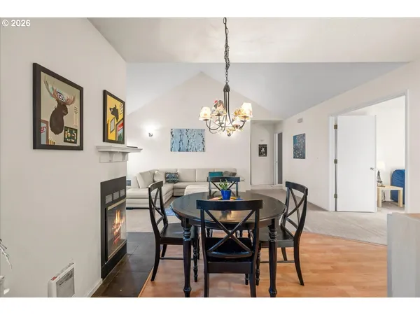 a view of a dining room with furniture and chandelier