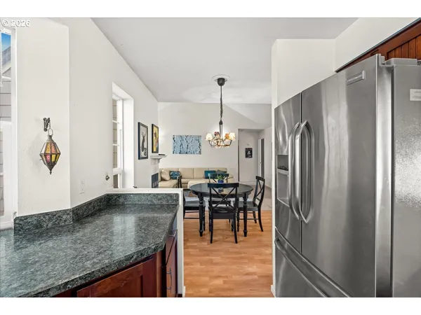 a kitchen with stainless steel appliances granite countertop a refrigerator and a sink