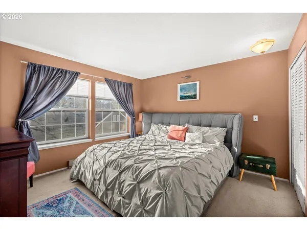 a bedroom with a bed and a large window