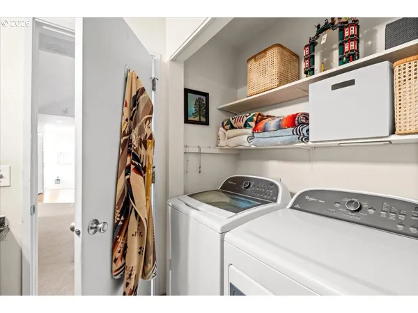 a utility room with dryer washer and other items