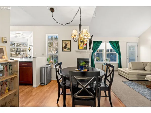 a view of a dining room with furniture and chandelier