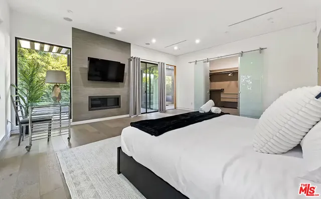 a bedroom with a bed and a flat screen tv