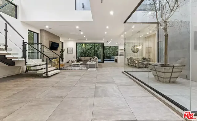 a lobby with furniture and a large mirror
