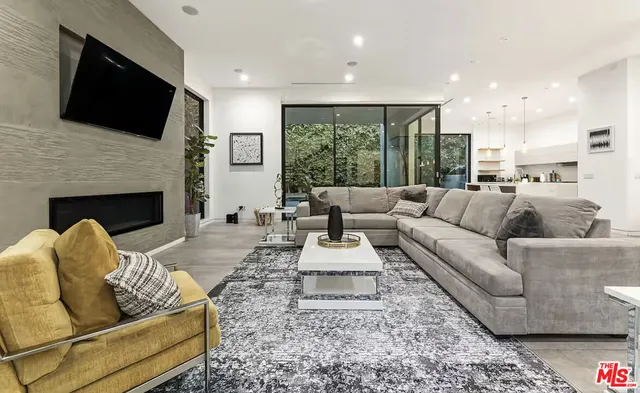 a living room with furniture fireplace and flat screen tv
