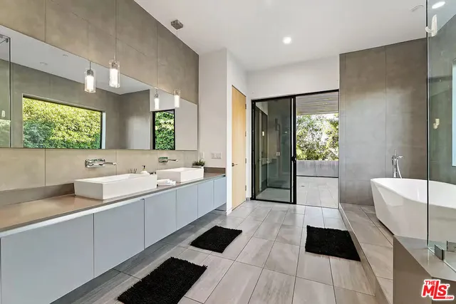 a large bathroom with a large tub and sink