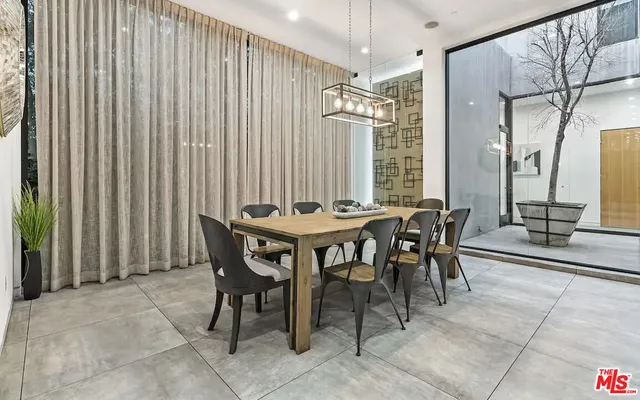 a view of a dining room with furniture and a chandelier