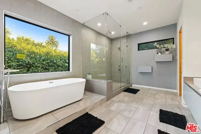 a bathroom with a bathtub and shower
