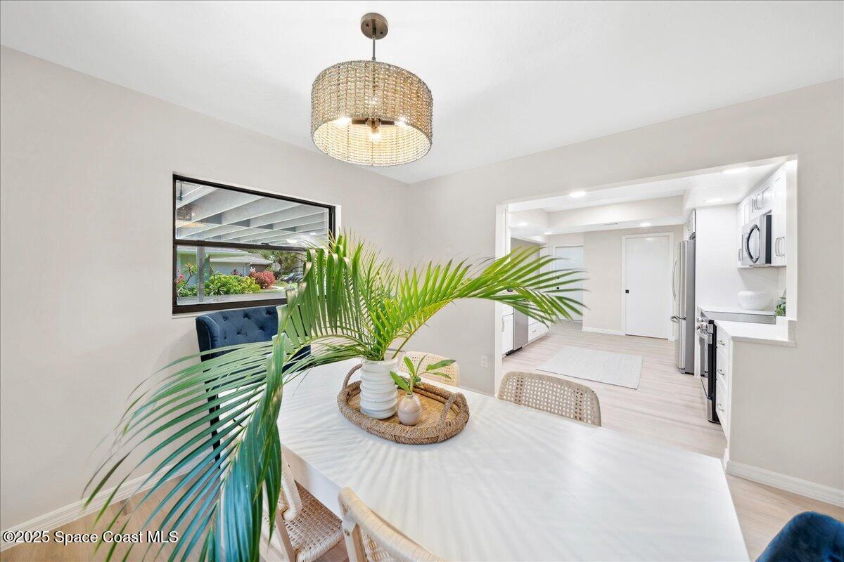 6315 Anchor Lane Rockledge, FL 32955 - Photo 12 of 52 a view of a dining room with furniture and a chandelier