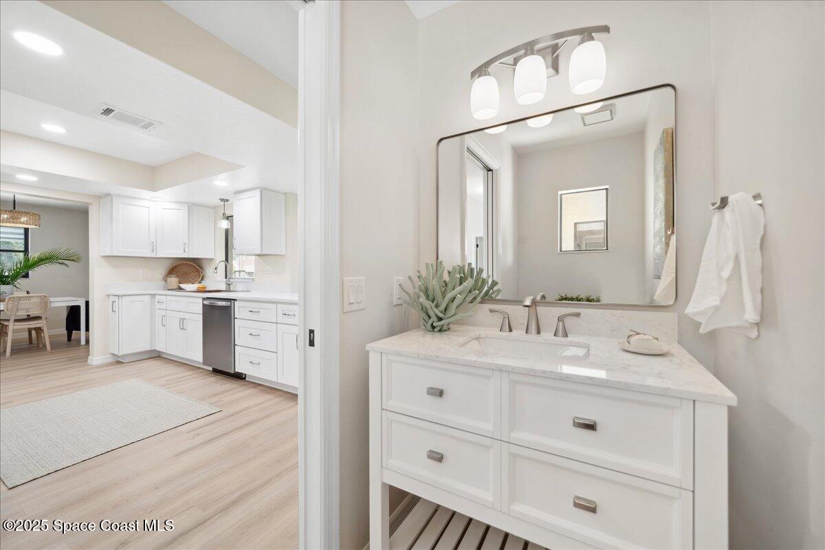 6315 Anchor Lane Rockledge, FL 32955 - Photo 14 of 52 a bathroom with a sink vanity granite tub shower and a mirror