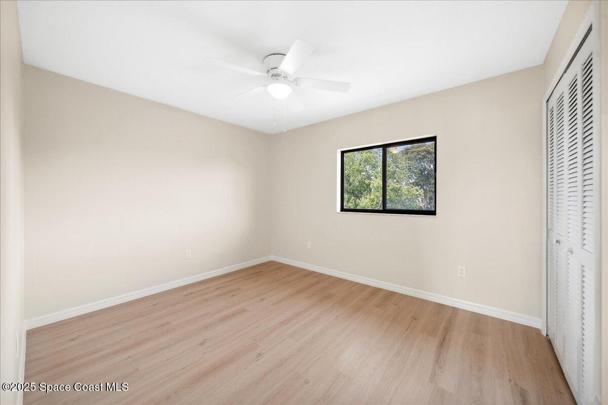 6315 Anchor Lane Rockledge, FL 32955 - Photo 26 of 52 an empty room with wooden floor and window