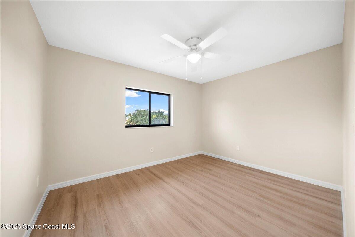 6315 Anchor Lane Rockledge, FL 32955 - Photo 28 of 52 an empty room with wooden floor fan and windows
