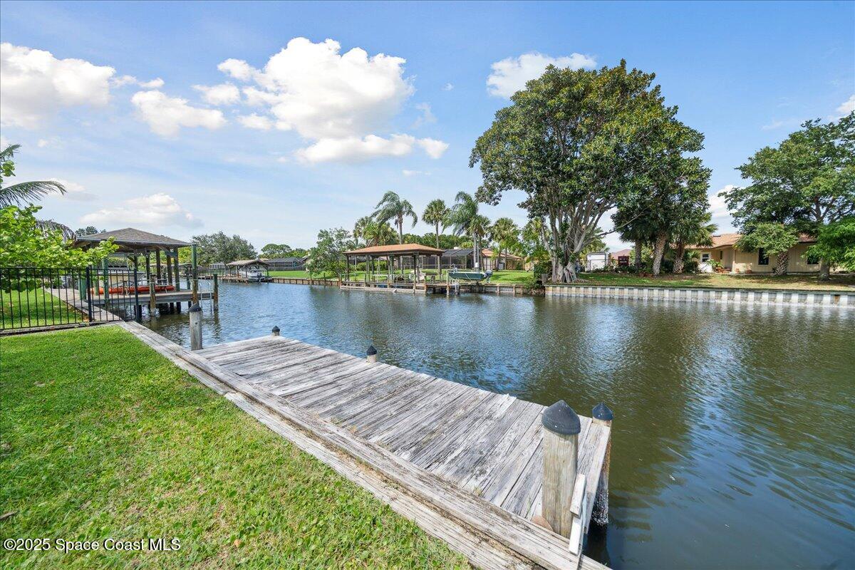 6315 Anchor Lane Rockledge, FL 32955 - Photo 40 of 52 a view of a lake with houses next to a lake