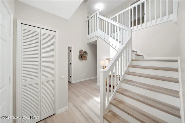 a view of staircase with wooden floor and a window