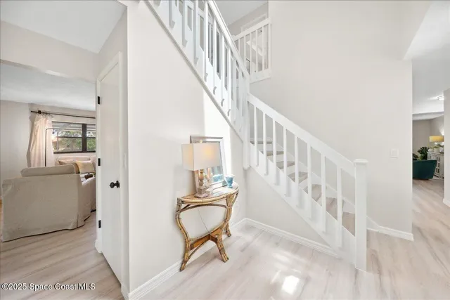 a view of entryway with wooden floor and a livingroom view