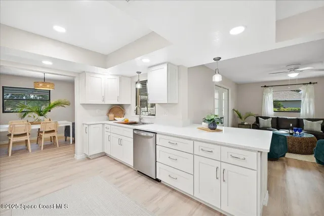 a large kitchen with kitchen island a sink table and chairs