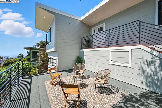 a view of a patio with table and chairs with wooden floor and fence