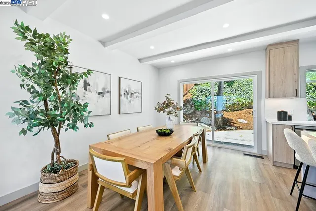 a spacious bedroom with a bed and a painting on the wall