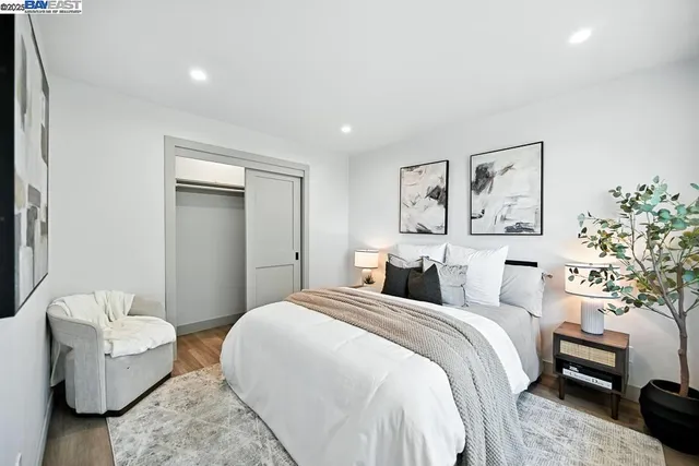 a bedroom with a large bed and a window